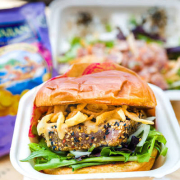 Seared Ahi Burger · Seasoned & seared on a brioche bun with onions, mixed greens, wontons & furikake. Served with mixed green or potato salad